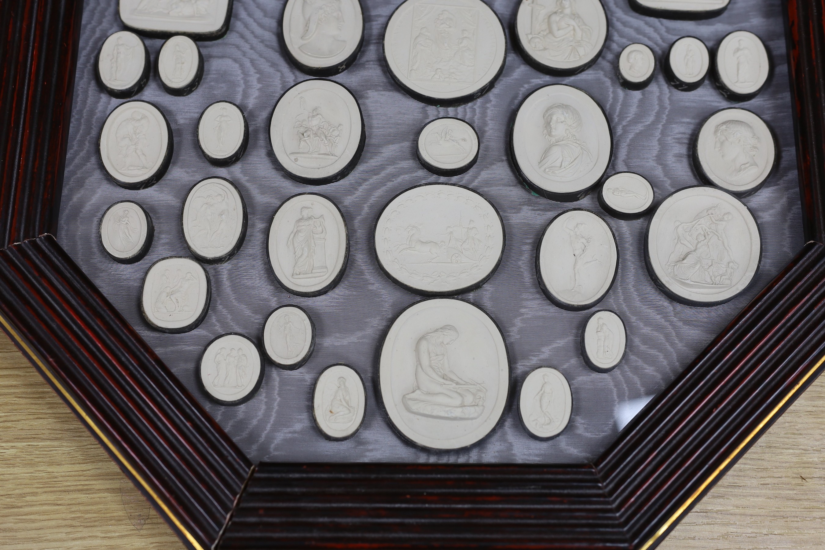 After the antique, a pair of octagonal framed grand tour plaster plaques, 44 x 44cm total